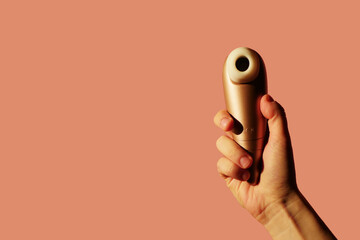 Woman holding clitoral vibrator. Sexual health. Copy space. Masturbation toy concept