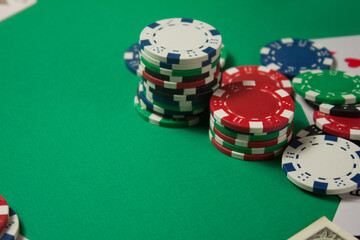 Classic playing cards, chips and dollars on green background with place for text. Gambling and casino concept.