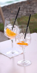 empty goblets with ice and orange slice on the table