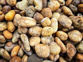 Many rocks piled up in landscape decoration. stones background wallpaper. Wet stones. Texture with stones. Background of small stones.