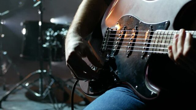 Guitarrest plugs in an electric guitar on stage.