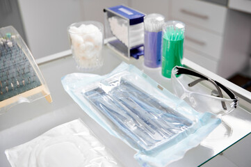 Close-up snapshot of dental instruments. Glass table in dentist office with all necessary tools for...