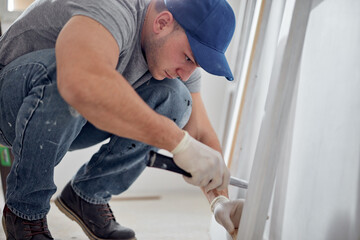 Fototapeta premium Young adult man working on a DIY budget renovation of his new home apartment.