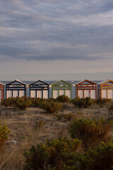 Fototapeta na wymiar Multicolored bathing huts on the Costa Brava at the beach of Sant Pol, Sant Feliu de Guixols