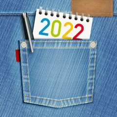 Fotobehang Concept de l’éducation scolaire et du cursus universitaire pour une carte de vœux 2022 avec une poche de blue-jeans et un bloc note comme symbole de la jeunesse. © pict rider