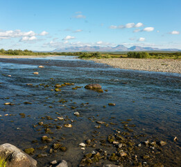 Summer river landscape with cloudy sky. Nature background, riverbank.