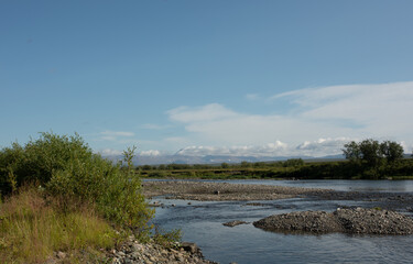 Summer river landscape with cloudy sky. Nature background, riverbank.