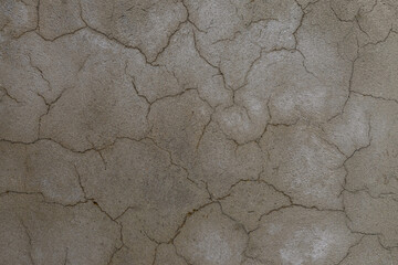 cracked concrete wall covered with gray cement surface as background