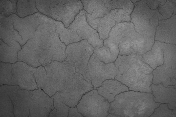 cracked concrete wall covered with gray cement surface as background black and white