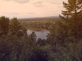 View from the mountain to the river and pine forest evening warm light