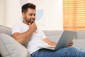 Man using laptop for online shopping at home