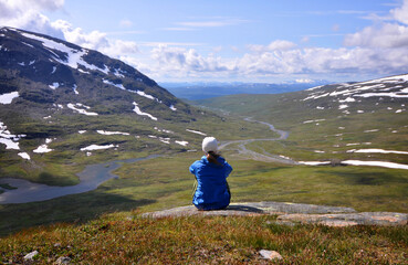 Hiker looking out over Viterskalet and Syterskalet along the King's Trail, Kungsleden, between...