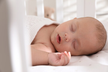 Cute little baby sleeping in crib, closeup