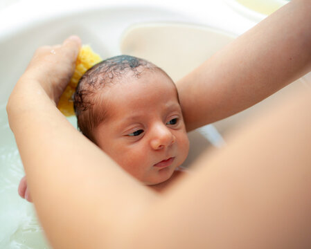 First bath of newborn baby boy.