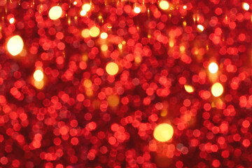 Red and golden sparkling glitter bokeh background, christmas abstract defocused texture. Holiday lights