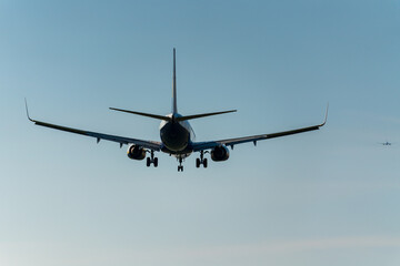 airplane prepares for landing with extended landing gear