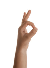 Naklejka premium Teenage boy showing ok gesture on white background, closeup