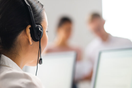 Diverse team of young professionals is working in the phone support office. Working day of sales managers in the call center. Business, telephone consulting and problem solving.