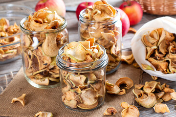 Fototapeta na wymiar Homemade dried organic apple sliced on wood table. Healthy eating. Vitamins. Vegetarian, vegan.