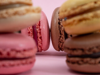 colorful macarons on pink background