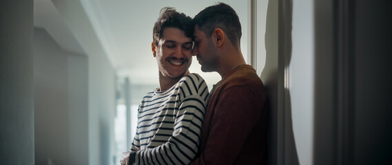 Gentle Scenes of a Stylish Young Adult Gay Couple Spend Time at Home. Two Happy Men in Love Stand in Corridor in Casual Clothes and Hug Each Other. Cute LGBT Relationship Content.