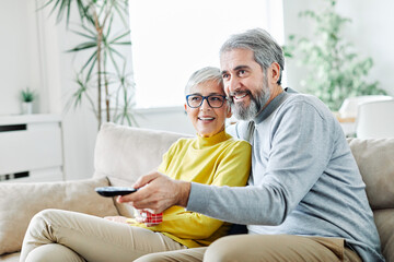 senior couple watching tv happy mature television together