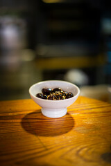 appetizer of black olive with seeds on a wooden table