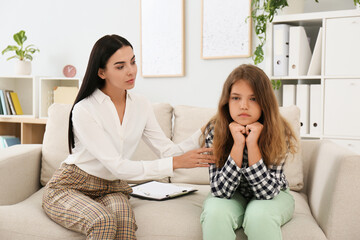 Young psychologist working with teenage girl in office