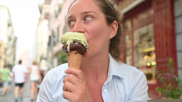 Woman eating an ice cream in San Remo, Italy