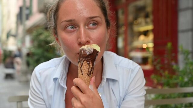 Woman eating an ice cream in San Remo, Italy