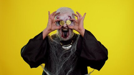 Joyful man with bloody scars face, Halloween zombie showing golden bitcoins. Achievement career...
