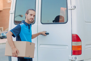 Delivery boy opening the van's door