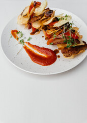 meat and potato chips salad. On a white background