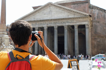 tourist photographer while discards memorable photos to the old ancient temple of the Pantheon in Rome