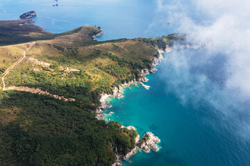 Turquoise sea and rocky coastline of autumn Gamow Peninsula, aerial view. The Peter the Great Gulf.