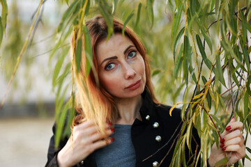 Fototapeta premium Portrait of beautiful woman in the park