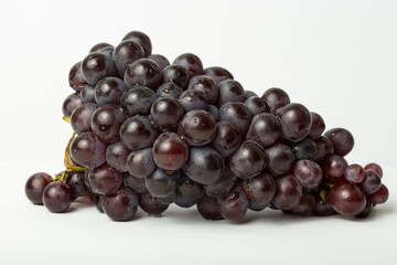 Bunch of organic blue-black grapes isolated on white background