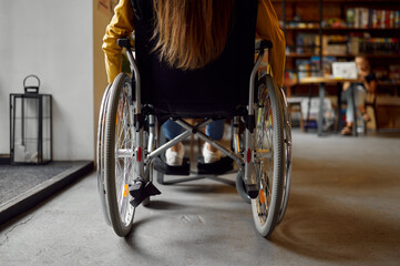 Fototapeta na wymiar Disabled female student in wheelchair, back view