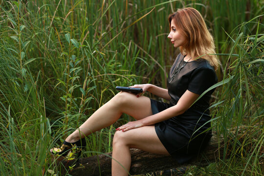 Woman with a gun in reeds