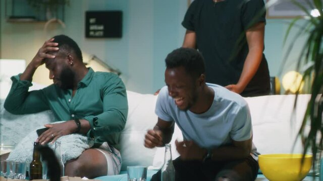 African American guy winning bet from disappointed friends