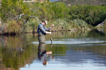 Fisherman catching fish in the river