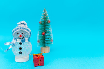 Toy snowman, presents and Christmas tree with copy space.new year celebration.