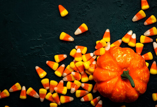 Halloween pumpkin and candy corn banner on blue baclground. Top view with copy space