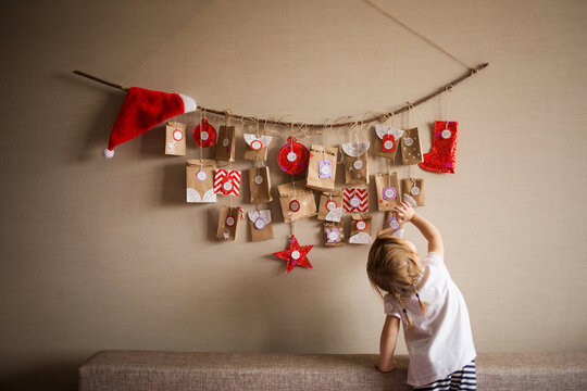 advent calendar for kid is hanging on table. children christmas concept
