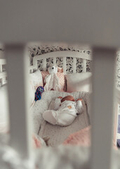 Newborn baby sleeping in a baby-cot. Selective focus.