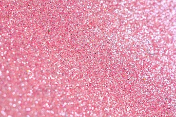 Abstract glittering pink glitter bokeh on blurry background.