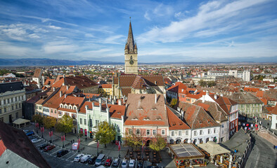 Aerial overview of Sibiu, Romania from the Council Tower with the Small Square (Piata Mica) and the ramp heading to the Lower town, while the Evanghelical Lutheran Cathedral dominates the skyline.