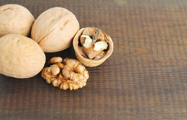 walnuts close-up on a dark brown wooden background. 