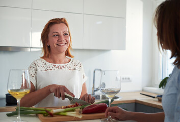 Obraz na płótnie Canvas Woman cooking food in kitchen.