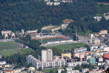 Fototapeta na wymiar Aerial view of Lugano on a sunny late summer morning with football stadium. Photo taken September 11th, 2021, Lugano, Switzerland.